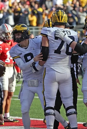 J.J. McCarthy (9) and Ryan Hayes (76)
