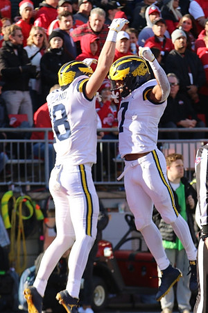 Colston Loveland (18) and Donovan Edwards (7)