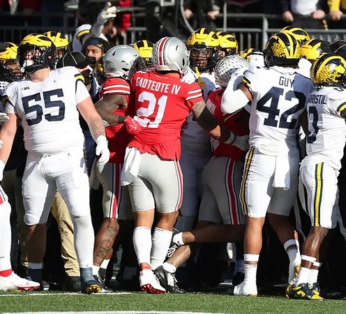 Mason Graham (55), TJ Guy (42), and Mike Sainristil (0)
