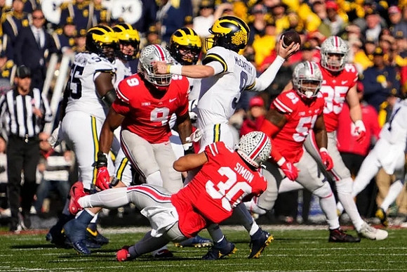 Zak Zinter (65) and J.J. McCarthy (9)