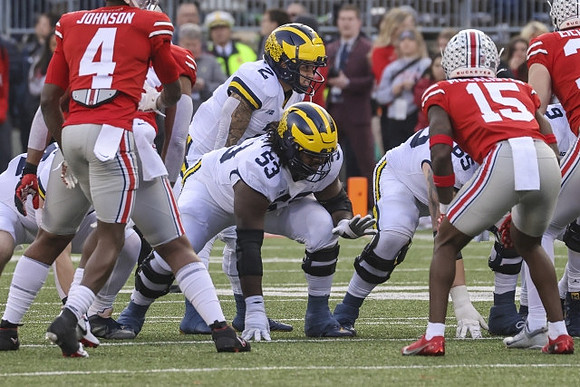 Trente Jones (53), Blake Corum (2), and Zak Zinter (65)