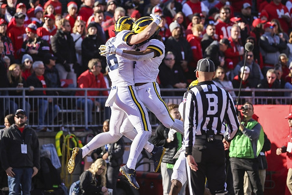 Colston Loveland (18) and Donovan Edwards (7)