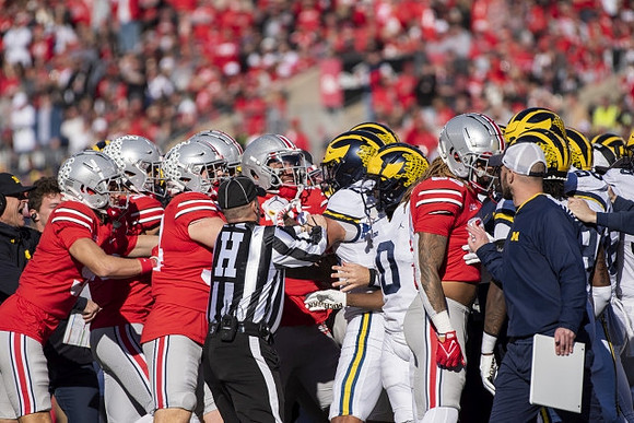 Mike Sainristil (0) and Michigan Team