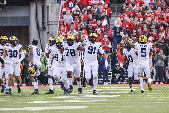 Jimmy Rolder (30), R.J. Moten (6), Cam Goode (99), Kenneth Grant (78), Taylor Upshaw (91), Mike Sainristil (0), and DJ Turner (5)