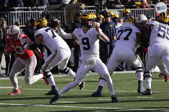 Ryan Hayes (76), J.J. McCarthy (9), Trevor Keegan (77), and Olusegun Oluwatimi (55)