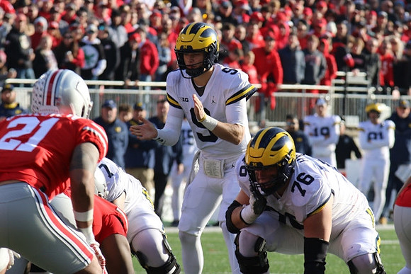 J.J. McCarthy (9) and Ryan Hayes (76)