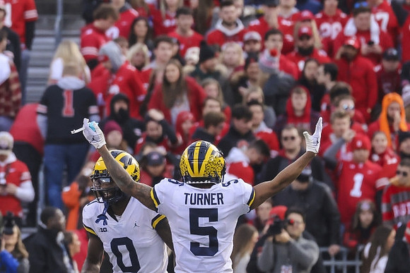 Mike Sainristil (0) and DJ Turner (5)