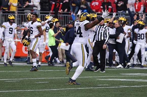 J.J. McCarthy (9), Cornelius Johnson (6), Kris Jenkins (94), and Michigan Team