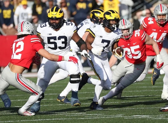 Trente Jones (53) and Donovan Edwards (7)