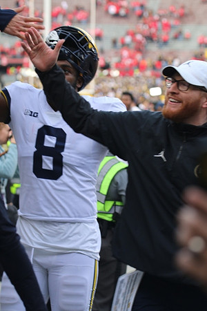 Derrick Moore (8) and Jay Harbaugh