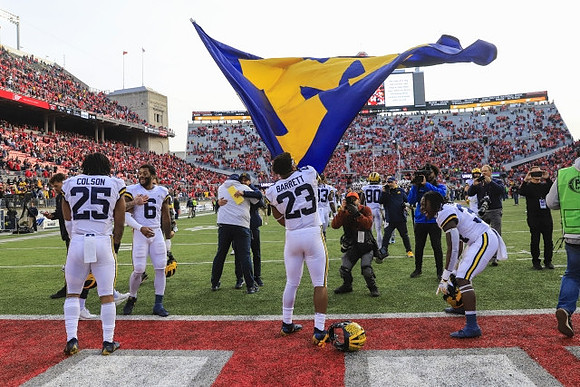 Junior Colson (25), Michael Barrett (23), and Michigan Team