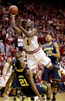 Zak Irvin (21), Derrick Walton Jr. (10), and Jon Horford (15)