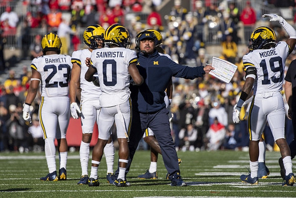 Michael Barrett (23), Mike Sainristil (0), and Rod Moore (19)