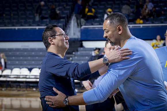 Michigan President Santa Ono  and Juwan Howard