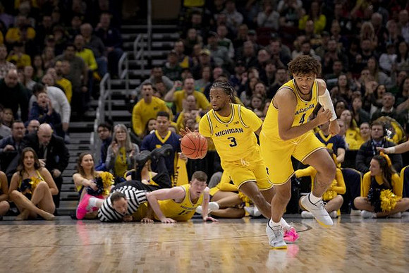Jon Teske (15), Zavier Simpson (3), and Isaiah Livers (4)