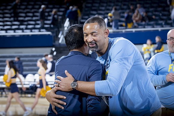 Michigan President Santa Ono  and Juwan Howard