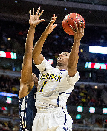 Jon Horford (15) and Trey Burke (3)
