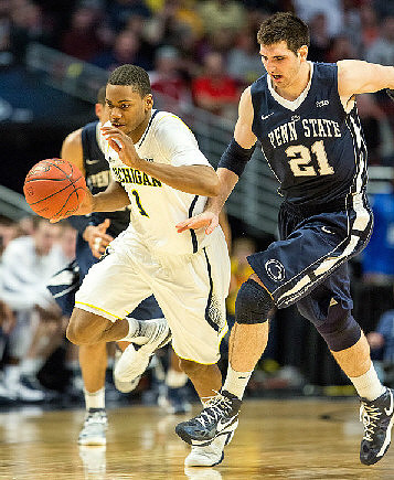 Trey Burke (3), John Beilein, and Jon Horford (15)