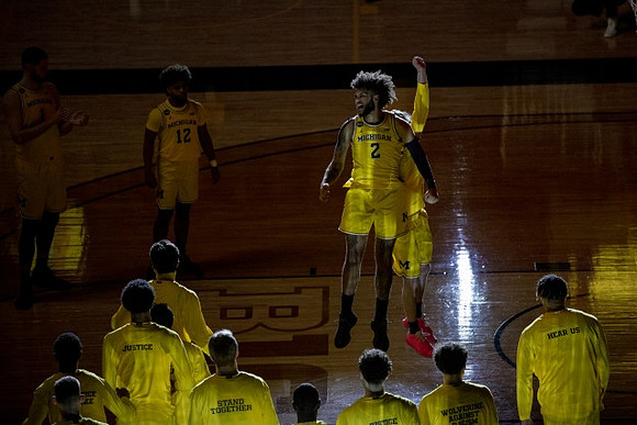 Mike Smith (12), Isaiah Livers (2), and Michigan Team