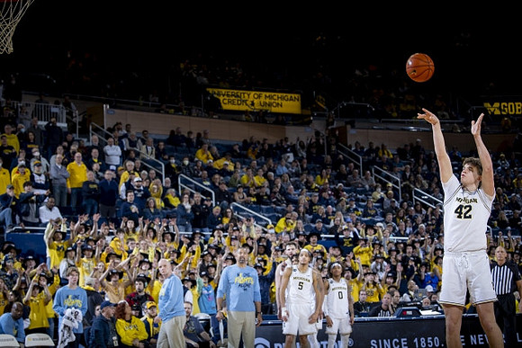 Will Tschetter (42) and Michigan Team