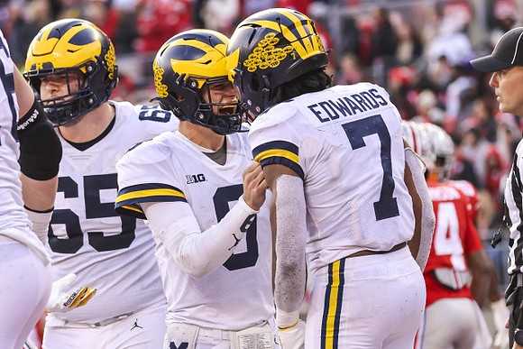 Zak Zinter (65), J.J. McCarthy (9), and Donovan Edwards (7)