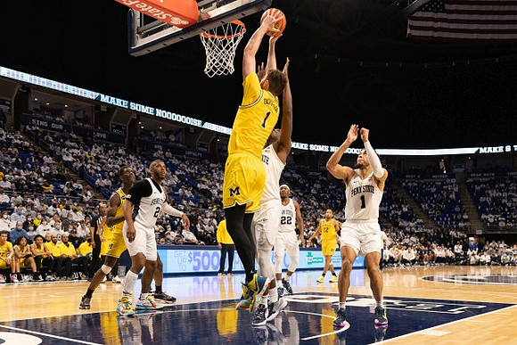 Moussa Diabate (14), Hunter Dickinson (1), and DeVante' Jones (12)