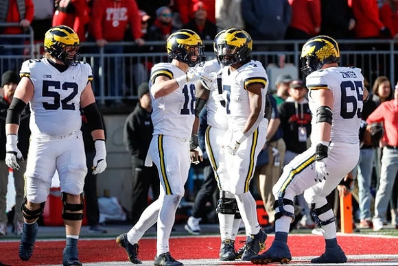 Karsen Barnhart (52), Colston Loveland (18), Donovan Edwards (7), and Zak Zinter (65)