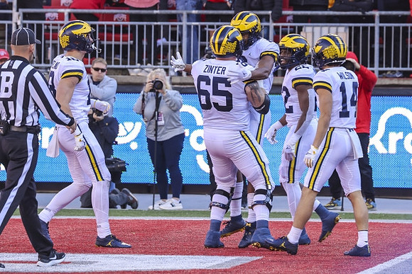Colston Loveland (18), Zak Zinter (65), Cornelius Johnson (6), Tavierre Dunlap (22), and Roman Wilson (14)