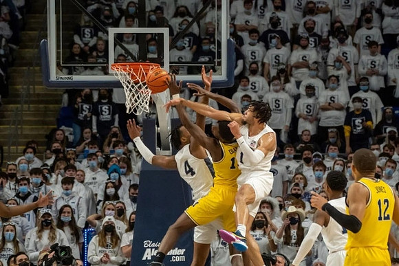 Moussa Diabate (14) and DeVante' Jones (12)