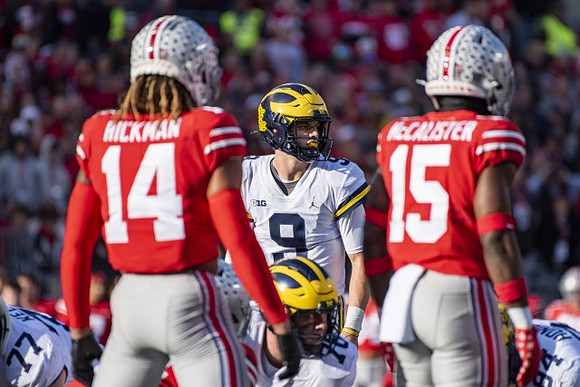 Trevor Keegan (77), J.J. McCarthy (9), Ryan Hayes (76), and Joel Honigford (84)