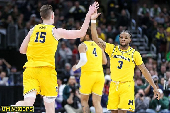 Jon Teske (15), Isaiah Livers (4), and Zavier Simpson (3)