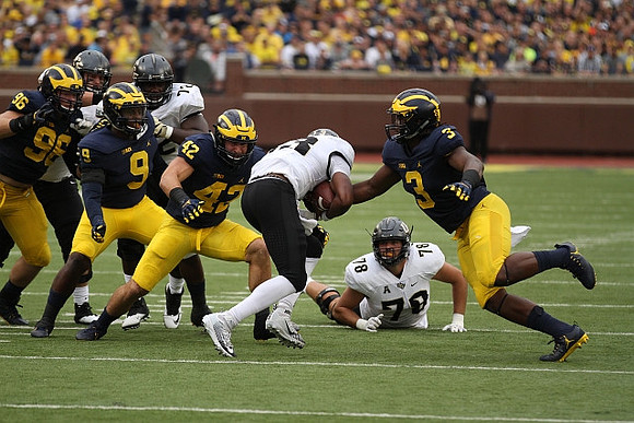 Matthew Godin (99), Mike McCray (9), Chris Wormley (43), and Rashan Gary (3)
