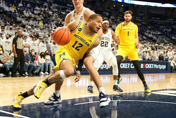 DeVante' Jones (12) and Hunter Dickinson (1)