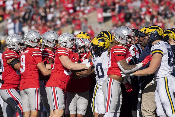 Mike Sainristil (0) and Luke Schoonmaker (86)