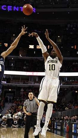Nik Stauskas (11) and Mitch McGary (4)