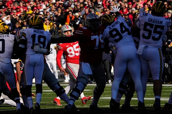 Mike Sainristil (0), Rod Moore (19), Kris Jenkins (94), and Mason Graham (55)