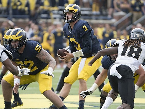 Mason Cole (52) and Wilton Speight (3)