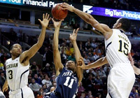 Trey Burke (3) and Jon Horford (15)