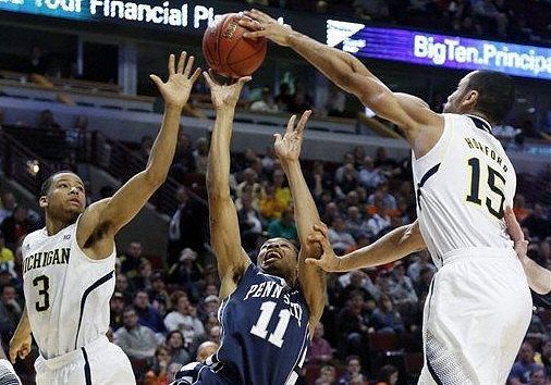 Trey Burke (3) and Jon Horford (15)