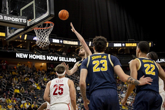 Hunter Dickinson (1), Brandon Johns Jr. (23), and Caleb Houstan (22)