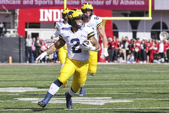 Blake Corum (2), Joel Honigford (84), and J.J. McCarthy (9)