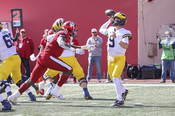 Zak Zinter (65) and J.J. McCarthy (9)