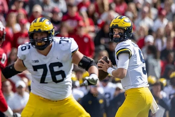 Ryan Hayes (76) and J.J. McCarthy (9)