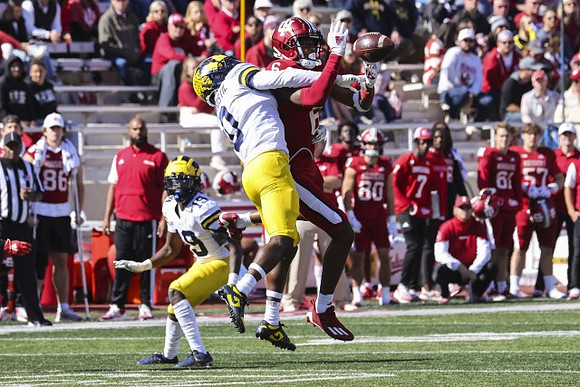 Rod Moore (19) and Mike Sainristil (0)