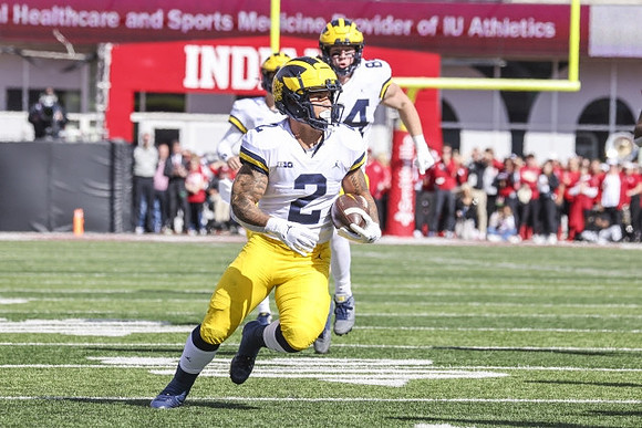 Blake Corum (2), Joel Honigford (84), and J.J. McCarthy (9)