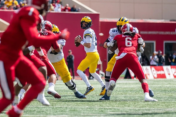 J.J. McCarthy (9) and Ryan Hayes (76)