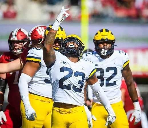 Mike Morris (90), Michael Barrett (23), and Jaylen Harrell (32)