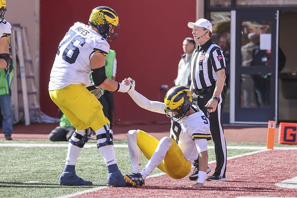 Ryan Hayes (76) and J.J. McCarthy (9)