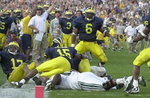 Victor Hobson (6), Larry Foote (17), Jim Herrmann, Brady Hoke, Lloyd Carr, DeWayne Patmon (15), Todd Howard (3), and Julius Curry (26)