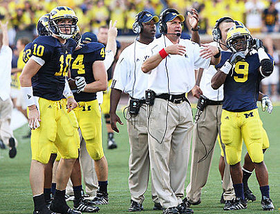 Steven Threet (10), Mark Moundros (44), Rich Rodriguez, and Martavious Odoms (9)